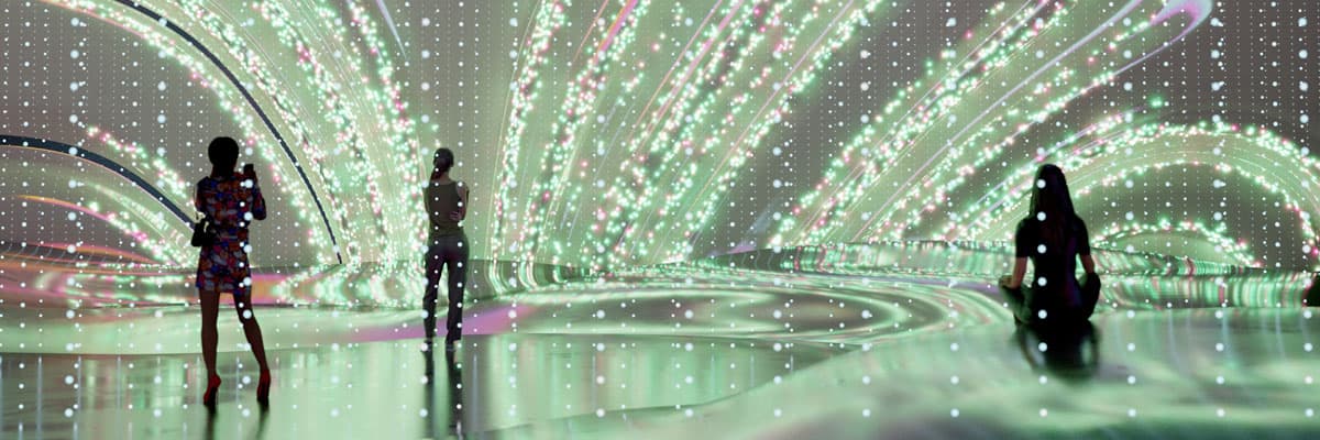 Wavy shapes displayed on a large digital screen in a room